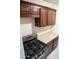 Close-up of the kitchen range, countertops, and cabinetry with stainless steel appliances at 1914 W Colter St, Phoenix, AZ 85015