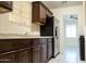 Kitchen featuring wood cabinets, stainless steel appliances, and tile flooring at 1914 W Colter St, Phoenix, AZ 85015