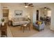 Inviting living room with neutral tones, ceiling fan, and comfortable seating near a dining area at 1914 W Colter St, Phoenix, AZ 85015