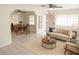 Bright living room with a modern design, tiled floors, and an open layout to the dining area at 1914 W Colter St, Phoenix, AZ 85015