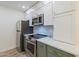 Well-equipped kitchen featuring stainless steel appliances, two-tone cabinetry, and bright white countertops at 1942 S Emerson -- # 211, Mesa, AZ 85210