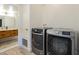 Functional laundry area with modern washer and dryer set and view into bathroom at 1942 S Emerson -- # 211, Mesa, AZ 85210