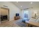 Well-lit living room featuring a decorative rug, light wood floors, and open doorway to a laundry space at 1942 S Emerson -- # 211, Mesa, AZ 85210
