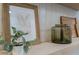 Stylishly decorated shelf with art, glass vase, and live plant at 1942 S Emerson -- # 211, Mesa, AZ 85210