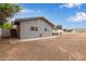 A spacious backyard with a patio and a wooden fence surrounds this single-Gathering home at 2022 E Mulberry Dr, Phoenix, AZ 85016