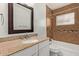 Bathroom with decorative brown tile, a large mirror, and granite vanity at 2022 E Mulberry Dr, Phoenix, AZ 85016