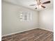Bright bedroom featuring wood-look flooring, a ceiling fan, and two windows at 2022 E Mulberry Dr, Phoenix, AZ 85016