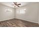 Bright bedroom featuring wood-look flooring, a ceiling fan, and two windows at 2022 E Mulberry Dr, Phoenix, AZ 85016