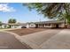Street view of a single-story home featuring a convenient carport and a long driveway at 2022 E Mulberry Dr, Phoenix, AZ 85016