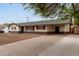 Street view of a single-story home featuring a convenient carport and long driveway at 2022 E Mulberry Dr, Phoenix, AZ 85016
