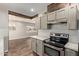 Well-lit kitchen showcasing stainless steel oven, range hood, white tile backsplash, and wood accents at 2022 E Mulberry Dr, Phoenix, AZ 85016