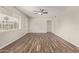 Spacious living room with hardwood floors, a ceiling fan, a white door, and neutral-colored walls at 2022 E Mulberry Dr, Phoenix, AZ 85016