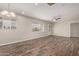 Open living room with hardwood flooring, large windows, ceiling fan, and light colored walls at 2022 E Mulberry Dr, Phoenix, AZ 85016