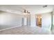 Large bedroom with tile floors, ceiling fan, neutral walls, and open doorway to the attached bathroom at 20427 W Mountain Sage Dr, Buckeye, AZ 85326