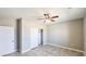 Well-lit bedroom features a closet, ceiling fan, neutral walls, and tile flooring at 20427 W Mountain Sage Dr, Buckeye, AZ 85326