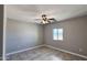 Bright bedroom with a ceiling fan, neutral walls, and tile flooring and bright window at 20427 W Mountain Sage Dr, Buckeye, AZ 85326