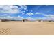 A sweeping view of this rural desert property shows endless possibilities under a bright blue sky at 20427 W Mountain Sage Dr, Buckeye, AZ 85326