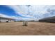 Open land showcases a rural community with similar single-story homes and expansive desert surroundings at 20427 W Mountain Sage Dr, Buckeye, AZ 85326