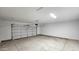 Spacious garage with white door and light concrete floor at 20427 W Mountain Sage Dr, Buckeye, AZ 85326