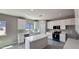 Stylish kitchen with a center island, stainless steel appliances, and modern cabinetry and grey walls at 20427 W Mountain Sage Dr, Buckeye, AZ 85326
