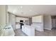 Bright, open kitchen featuring a center island, stainless steel appliances, and white cabinetry at 20427 W Mountain Sage Dr, Buckeye, AZ 85326