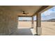 Covered patio featuring a ceiling fan, concrete flooring, and views of the surrounding area at 20427 W Mountain Sage Dr, Buckeye, AZ 85326