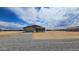 Gravel driveway leading to a house with desert landscaping and clear skies in the background at 20427 W Mountain Sage Dr, Buckeye, AZ 85326