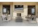 Inviting outdoor seating area with fireplace, TV, and comfortable chairs perfect for relaxation and entertainment at 20486 E Via Del Jardin --, Queen Creek, AZ 85142