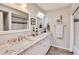 Bright bathroom featuring a double sink vanity with granite countertops and modern fixtures at 2328 W Nopal Ave, Mesa, AZ 85202