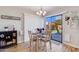 Cozy dining area with sliding glass doors leading to the backyard and a stylish chandelier at 2328 W Nopal Ave, Mesa, AZ 85202