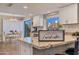 Well-lit kitchen featuring granite countertops, white cabinets, and view of dining area and backyard at 2328 W Nopal Ave, Mesa, AZ 85202