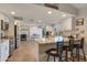 Bright kitchen with granite countertops, white cabinetry, stainless steel appliances, and breakfast bar seating at 2328 W Nopal Ave, Mesa, AZ 85202