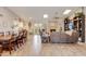 Spacious open-concept living area featuring wood-look tile flooring, a stone fireplace, and ample seating at 2328 W Nopal Ave, Mesa, AZ 85202