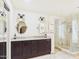 Bright bathroom showcasing double sinks with granite countertops and a glass-enclosed shower at 2331 E Melrose St, Gilbert, AZ 85297
