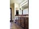 Bathroom featuring tile countertops, warm wood cabinets and a large mirror at 2331 E Melrose St, Gilbert, AZ 85297