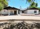 Charming white home featuring a covered entry, decorative accents, and a well-manicured front yard at 2331 E Melrose St, Gilbert, AZ 85297