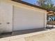 A spacious garage with a closed white door, showcasing exterior access and a sturdy build at 2331 E Melrose St, Gilbert, AZ 85297