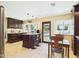 Spacious kitchen features granite counters, dark cabinets, travertine floors, and a breakfast bar seating area at 2331 E Melrose St, Gilbert, AZ 85297