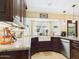 Well-appointed kitchen featuring granite countertops, a farmhouse sink, and stainless steel appliances at 2331 E Melrose St, Gilbert, AZ 85297