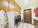 Bright laundry room featuring a front load washer and dryer and lots of cabinet storage at 2331 E Melrose St, Gilbert, AZ 85297