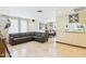 Inviting living area with a comfortable gray sectional couch, travertine floors, and large bright windows at 2331 E Melrose St, Gilbert, AZ 85297