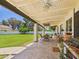 Relaxing covered patio with tile flooring, comfortable seating, and a view of the lush backyard at 2331 E Melrose St, Gilbert, AZ 85297