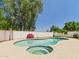 A kidney-shaped pool and spa are surrounded by mature landscaping and a privacy fence at 2331 E Melrose St, Gilbert, AZ 85297