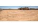 Large, flat backyard surrounded by a block fence, perfect for recreation at 23408 W Barwick Dr, Wittmann, AZ 85361