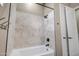 Beautifully tiled shower and tub with modern fixtures and tile surround at 23408 W Barwick Dr, Wittmann, AZ 85361