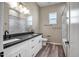 Bright bathroom featuring a double vanity, black hardware, and modern fixtures at 23408 W Barwick Dr, Wittmann, AZ 85361