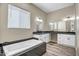 Bathroom features a soaking tub, dual vanities, and attractive flooring at 23408 W Barwick Dr, Wittmann, AZ 85361