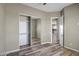 Bedroom features a mirrored closet, wood-look floors and neutral paint at 23408 W Barwick Dr, Wittmann, AZ 85361
