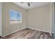 Bedroom featuring wood-look floors, neutral paint and a bright window at 23408 W Barwick Dr, Wittmann, AZ 85361