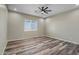 Bright bedroom featuring a ceiling fan, modern recessed lighting, and sleek wood-look flooring at 23408 W Barwick Dr, Wittmann, AZ 85361